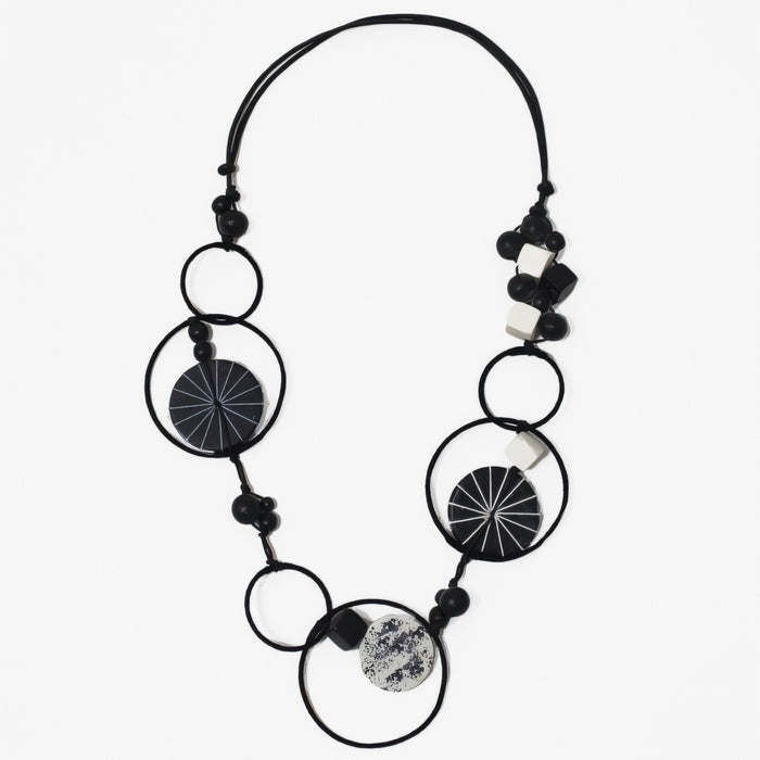 Necklace with black and white circular beads on a white background
