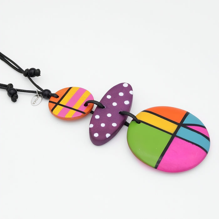 Colorful necklace with round, multicolored pendants on a white background