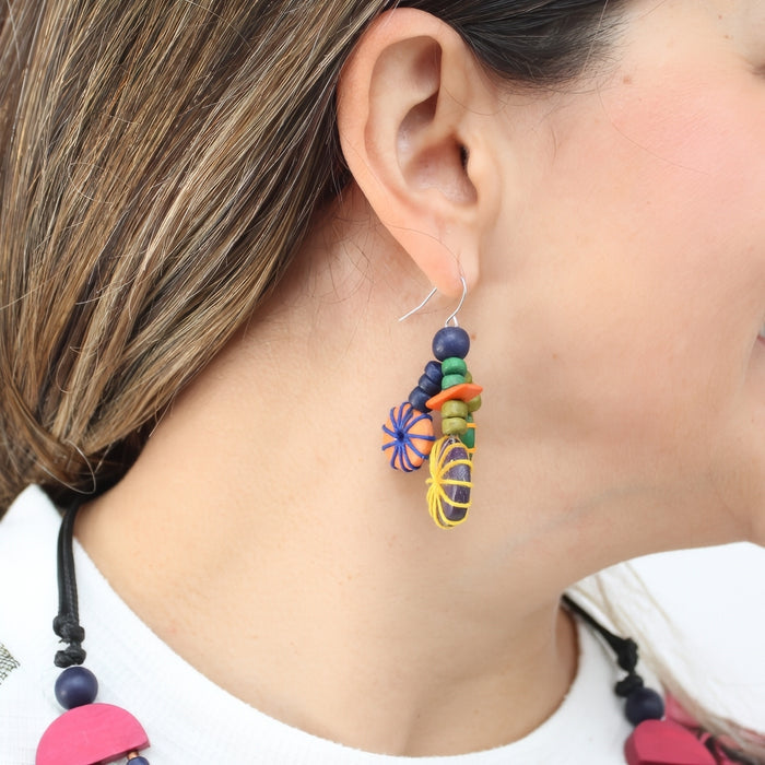 Close-up of a colorful beaded earring worn by a person.