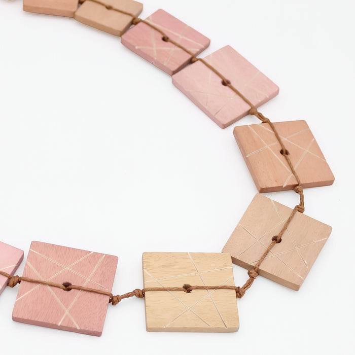 Necklace with square wooden beads on a white background
