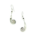 Silver earrings with pearl centers on a white background