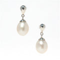 A pair of pearl drop stud earrings with silver top and bottom caps and lustrous pearls hanging in between.