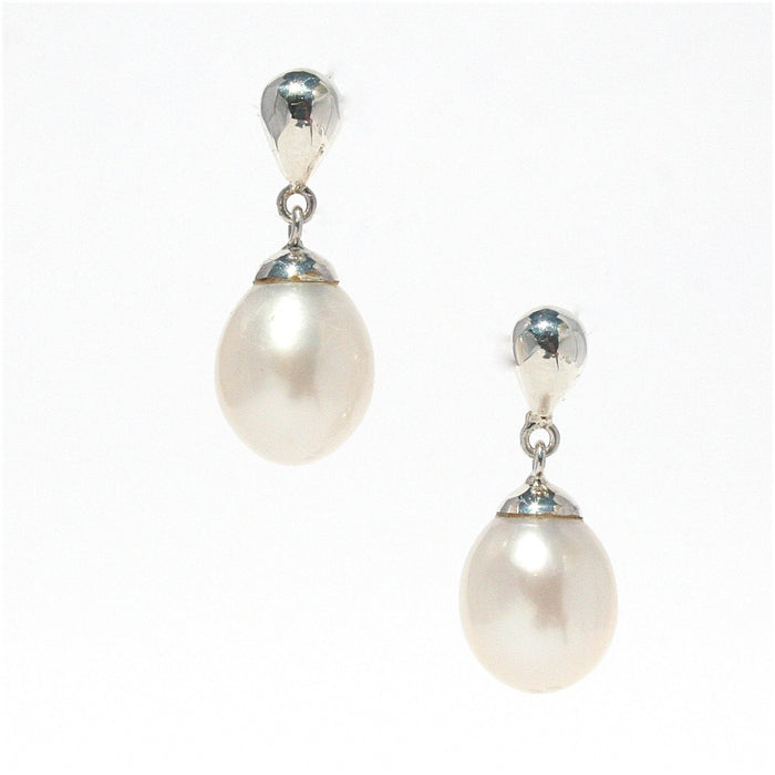 A pair of pearl drop stud earrings with silver top and bottom caps and lustrous pearls hanging in between.
