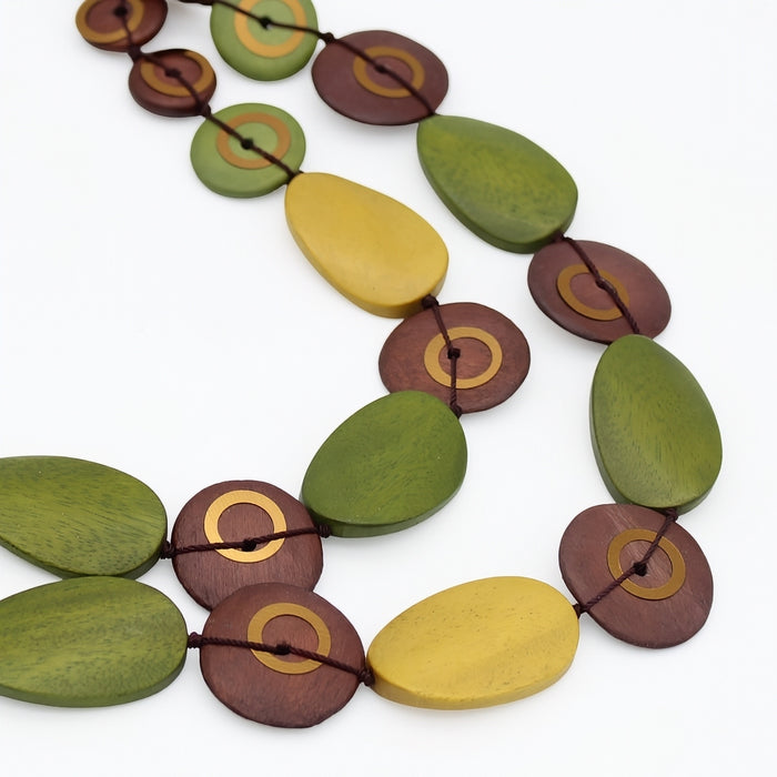 Close up of olive green, mustard and brown wood necklace details