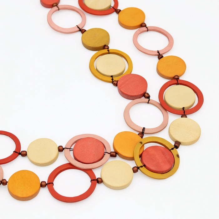 Colorful necklace with circular and ring-shaped beads on a white background