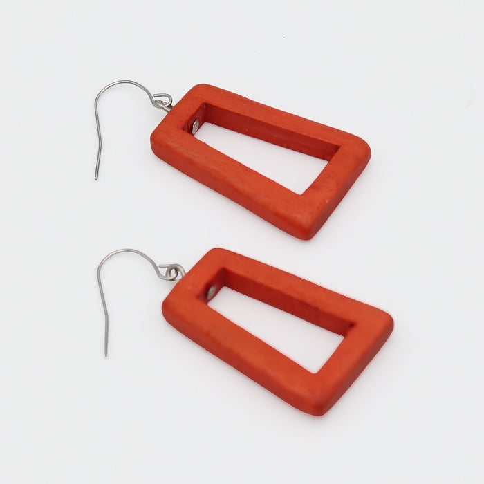 Pair of orange square earrings on a white background