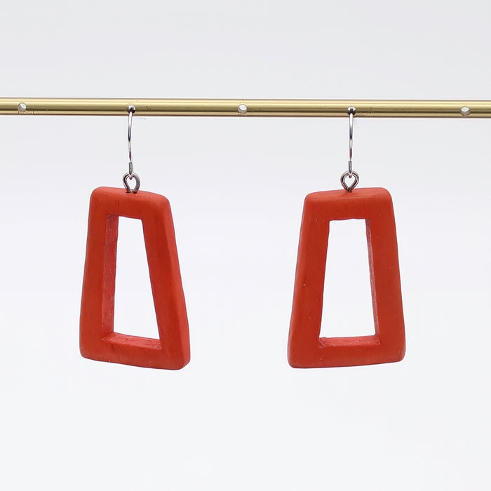 Red square-shaped earrings on a white background