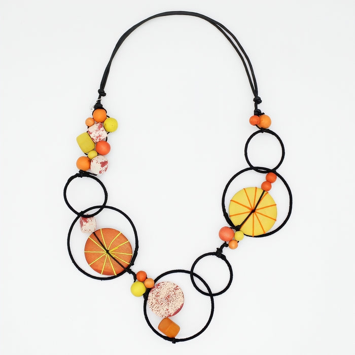 Necklace with circular black links and colorful beads on a white background