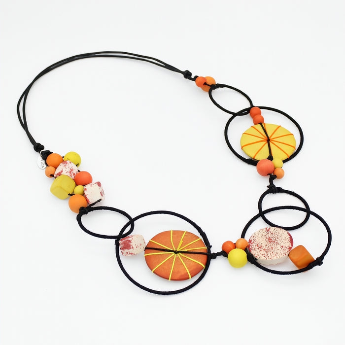 Colorful necklace with circular and spherical beads on a white background