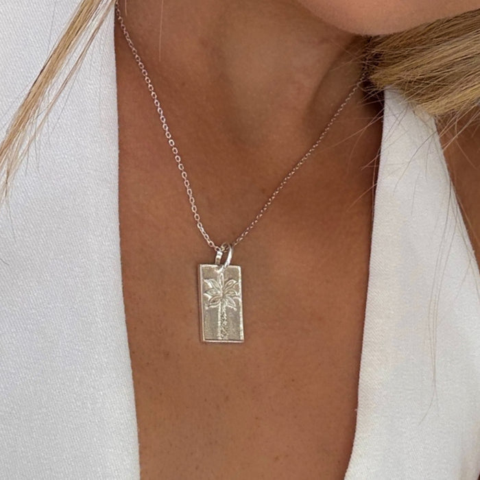 Sterling silver palm tree pendant necklace worn model coastal Australian jewellery Broome design