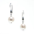 A pair of pearl tear drop earrings with round pearls on sterling silver shephard hooks.