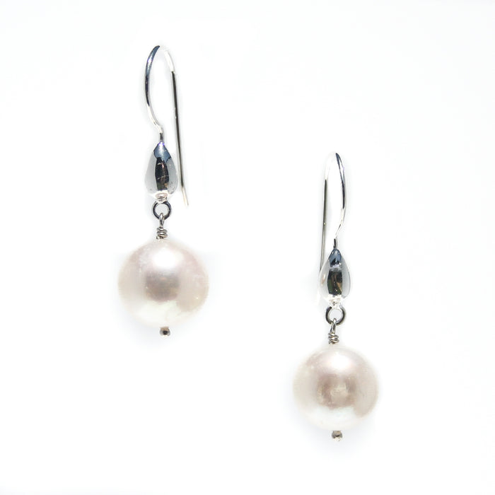 A pair of pearl tear drop earrings with round pearls on sterling silver shephard hooks.