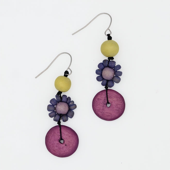 Pair of earrings with purple and yellow beads on a white background