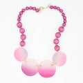 Necklace with pink and white beaded design on a white background