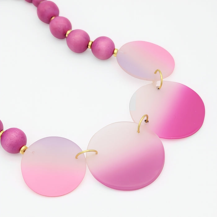 Necklace with pink and purple gradient beads on a white background