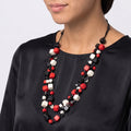 stunning double-strand floating bead necklace featuring small wooden beads in bold red, classic black, and off white