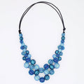 Necklace with blue and aqua beads on a white background