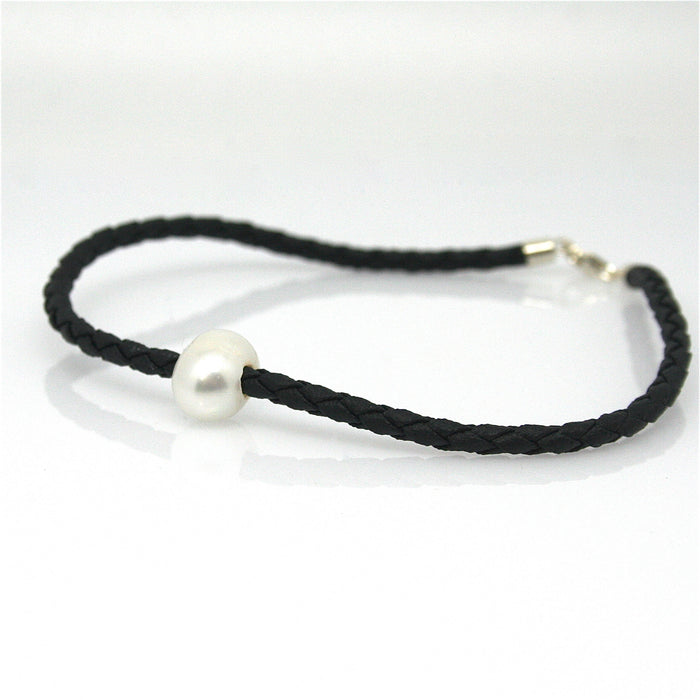 A black braid anklet with a single white pearl and a sterling silver lobster clasp.