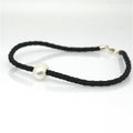 A black braid anklet with a single white pearl and a sterling silver lobster clasp.