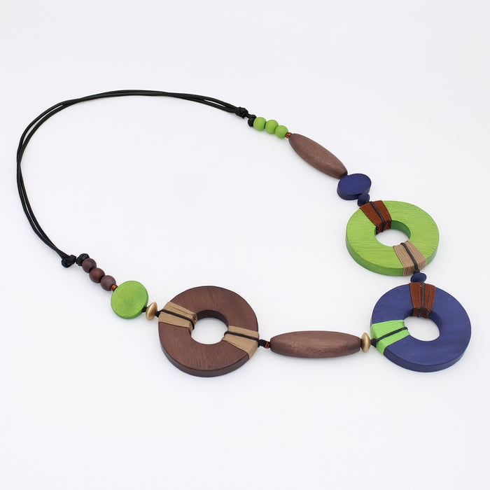 Colorful, green, blue and brown necklace with wooden beads on a white background