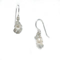 A pair of sterling silver pearl earrings with labradorite details, designed to resemble seashells.