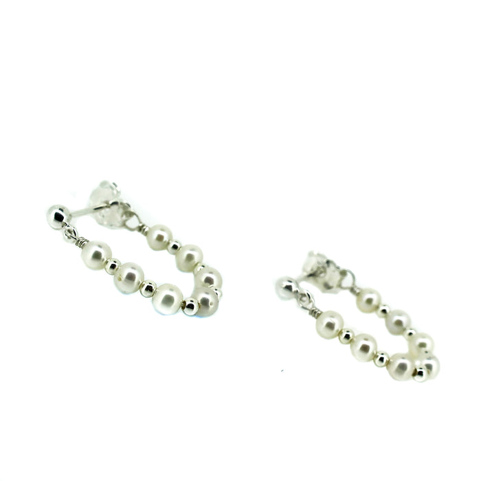 Pair of pearl loop earrings on a white background