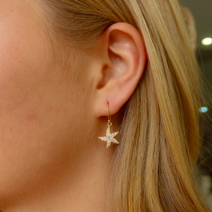 Seastar sparkle earrings gold vermeil with cubic zirconia starfish design worn by model beachy style