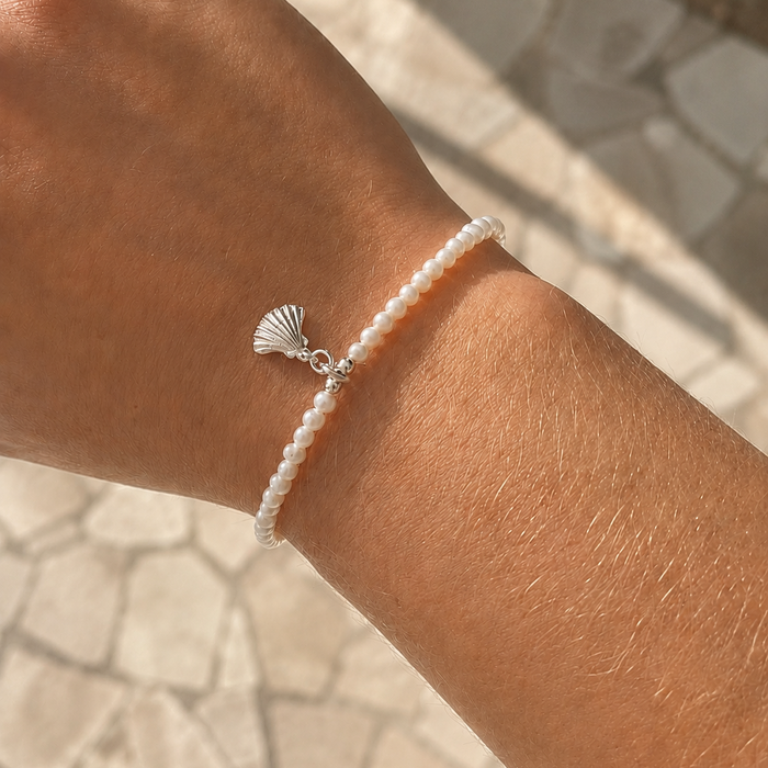 dainty seed pearl bracelet with silver shell charm