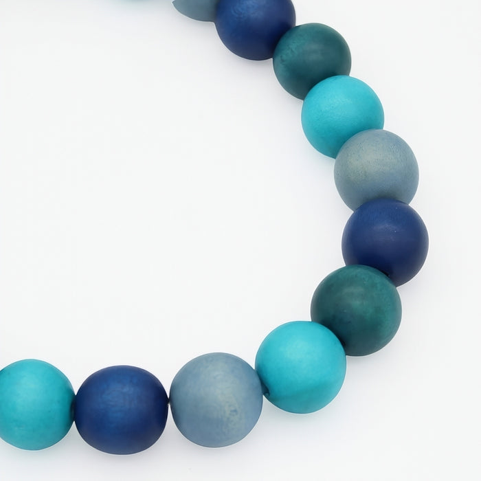 Necklace with blue and green beads on a white background