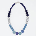 Necklace with blue and gray beads on a white background