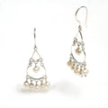 A pair of sterling silver earrings featuring seed pearls, with a boho design.