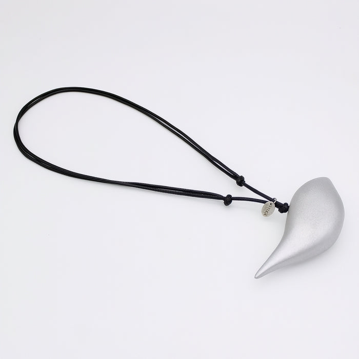 Silver pendant on a black cord against a white background