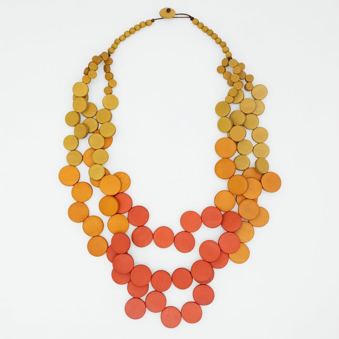 Necklace with orange and yellow colorful circular beads on a white background
