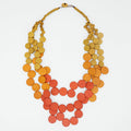 Necklace with orange and yellow colorful circular beads on a white background