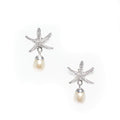 A pair of silver stud earrings featuring a starfish design with a freshwater pearl dangling below each earring.