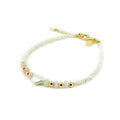 A handcrafted bracelet with white beads, pink opal stones, and gold accents, featuring a gold clasp.