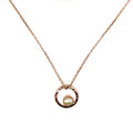 A rose gold necklace with a single pearl pendant, featuring a loop of rose gold at the top which appears to be the setting for the pearl.