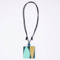 Necklace with a square pendant featuring a blue and beige design on a white background