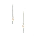 A pair of sterling silver thread earrings with white pearl accents.