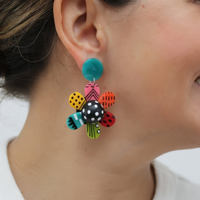 LARGE Colorful floral earring worn by a person