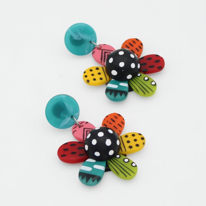 Colorful flower-shaped earrings with various patterns on a white background