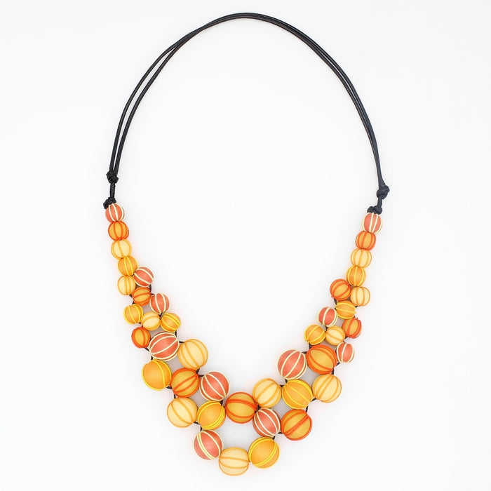 Necklace with orange and yellow beaded design on a white background