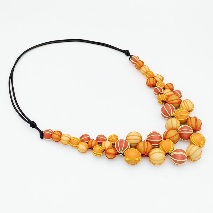 Necklace with orange and yellow beaded design on a white background