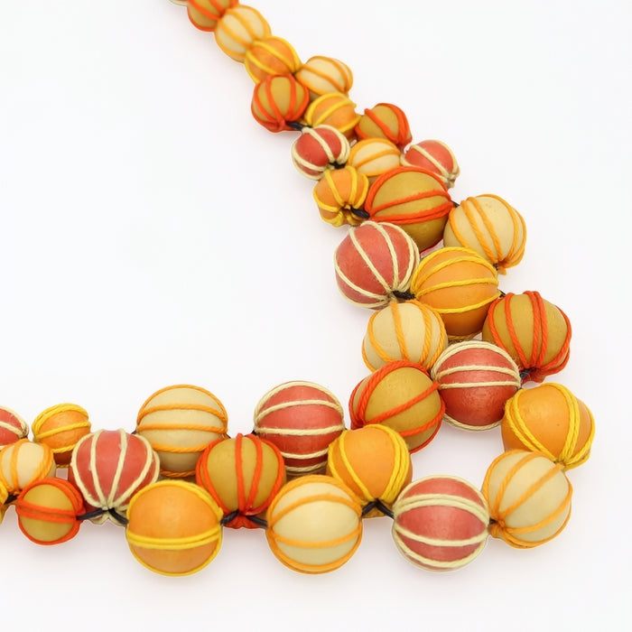 Necklace with multicolored striped beads on a white background