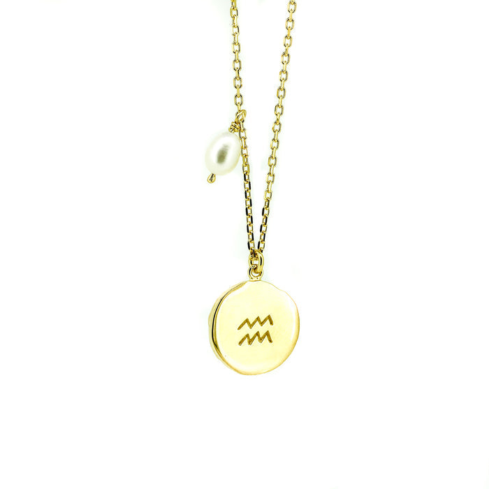 Gold Aquarius zodiac pendant on gold chain necklace