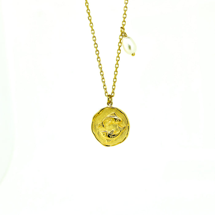 A gold necklace featuring a Pisces zodiac symbol and a pearl charm on a chain.
