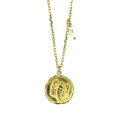 A gold vermeil necklace with a Scorpio zodiac sign pendant and a freshwater pearl drop.